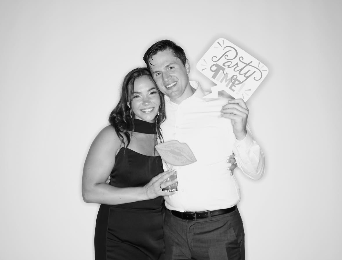 Photo booth rental Chicago - Wedding guests celebrating with photo booth prints and props at event